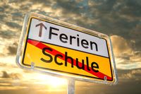 Straßenschild mit der Aufschrift ‚Ferien‘ und durchgestrichenem ‚Schule‘, passend zum Übergang von Schule zu Ferien. Ein perfektes ‚Schule Ferien Schild‘, das signalisiert: endlich Ferien!