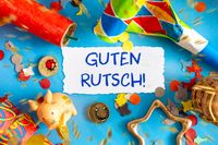 Guten Rutsch Sprüche zum Jahreswechsel. Bunte Neujahrsdekoration und der Schriftzug Guten Rutsch.