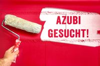 Azubi gesucht - Das Bild zeigt eine rote Wand mit einem angefangenen Schriftzug 